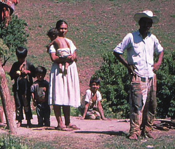 Family of Eustaquio. Kneeling in the background is the boy, Pipi, whose legs were paralyzed by polio when he was a baby.