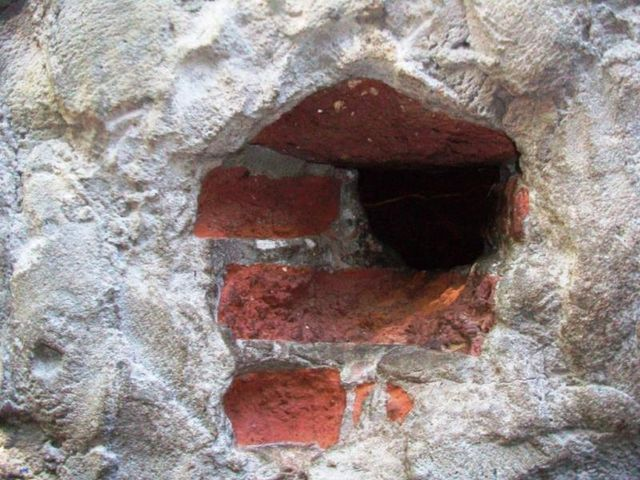 El agujero en la pared de ladrillos de un "búnker", a través del cual un "soldadito" vende drogas.