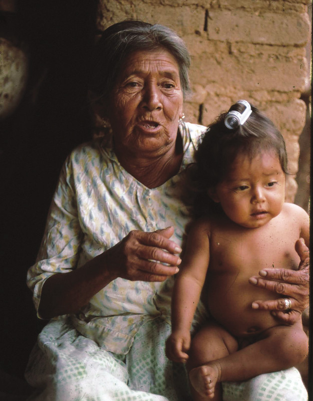 An old woman holds a baby.