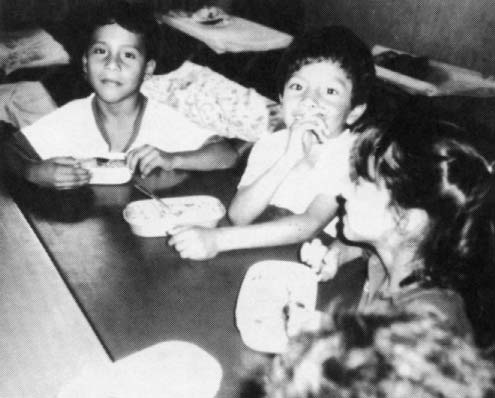 Children eat the daily meal they receive at CDI Colombia.