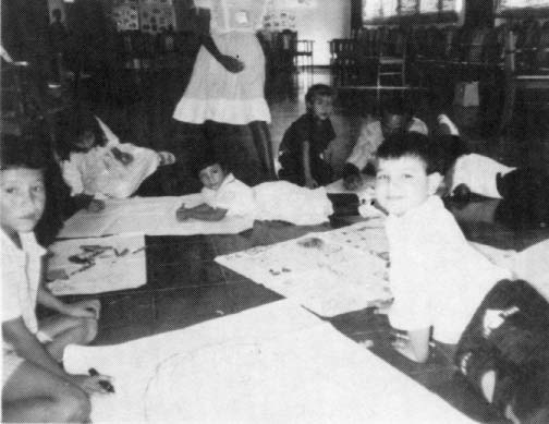 Children at Managua Child-to-Child workshop draw pictures of things that affect health in their communities.