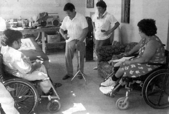 At PROJIMO's new base in Coyotitán, Mari Picos (right) and Dolores Mesina (left) help a man who had a stroke, and his wife, find new ways to cope with problems.