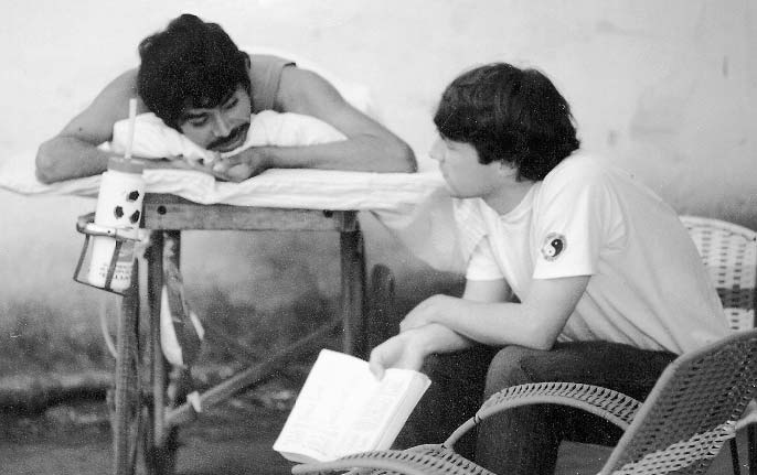 Quique, who was quadriplegic, had almost no control of his hands. He was one of the teachers in the intensive Spanish Language Training Program. Here, he is teaching an idealistic young North American physio-therapist. He is lying on a wheeled cot, or gurney, to allow the pressure sores on his backside to heal.