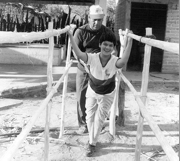 Eli’s father built these parallel bars for her. The high bars proved best for Eli to stand and walk.