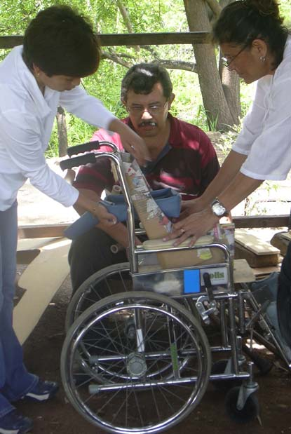 To accommodate a small child with flaccid cerebral palsy in an oversized wheelchair, this group made a cardboard insert-seat. They also made a wide variety of cardboard early-stimulation toys (see page 12).