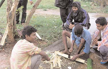 Artisan making a night split from bamboo.