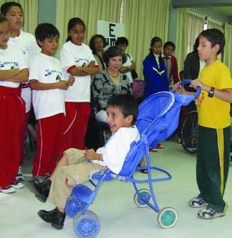 These children, by combining their abilities, are able to move about much more easily than either can alone.