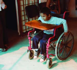 This boy with muscular dystrophy had been given a donated chair that was much too big, and difficult for him to push.