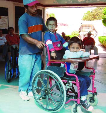 While his PROJIMO-made chair makes it easier for self-mobility around the house, his father says he will continue to use the bigger heavier chair to take the children to school. Why? Because he can transport both of them in the chair at once!