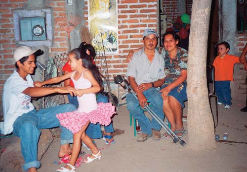 Marcelo and Chayo enjoyed watching their son, Jossue, dance with a neighbor girl in front of their home in Ajoya.