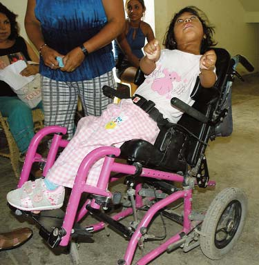 Estrella’s spastic pattern is triggered by the reclined position of her wheelchair.