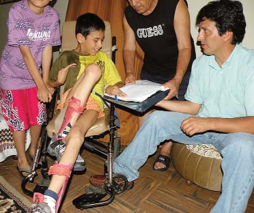 One thing Max indicated he wanted was an adjustable tray on his wheelchair, to help him learn to draw and write. Here, during the home visit, he demonstrates his potential.