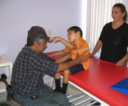 Raymundo Hernandez—who is himself paraplegic and leads the Duranguito wheelchair shop—evaluates a child for a wheelchair. Rigo cooperates closely with the shop in identifying children who need custom-made wheelchairs.