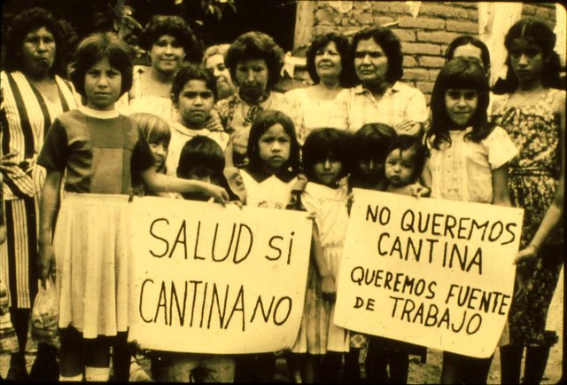 The women, with their children, protested outside the jail with signs saying HEALTH YES, SALOON NO and WE DON'T WANT A BAR, WE WANT SOURCES OF WORK.