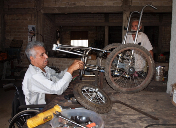 Raymundo, in the PROJIMO Duranguito workshop, working on the wheelchair carriage for Tonio.
