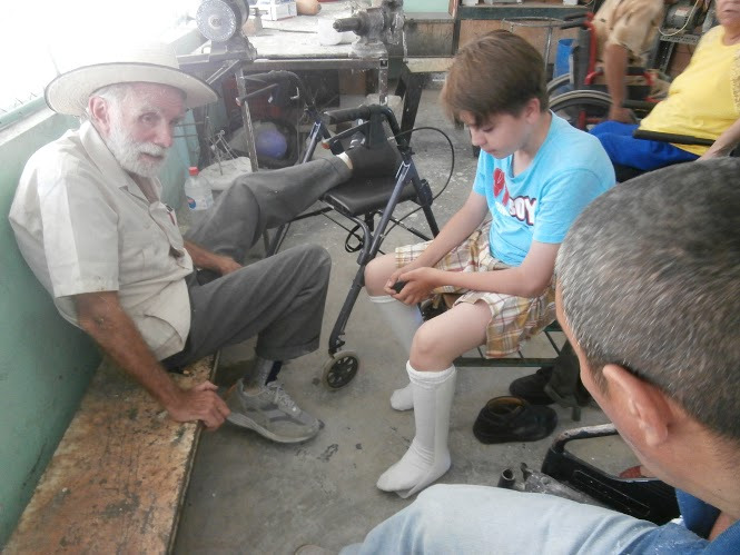 Tomás shows David his newly made braces.