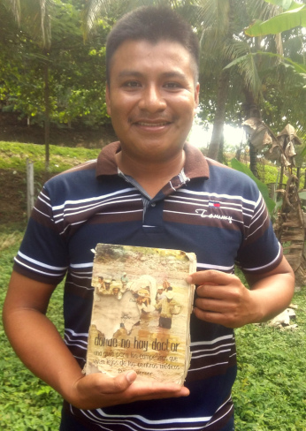 Village health promoter Werner Obeníel with his deceased father’s 35-year-old, dog-eared copy of Donde No Hay Doctor.