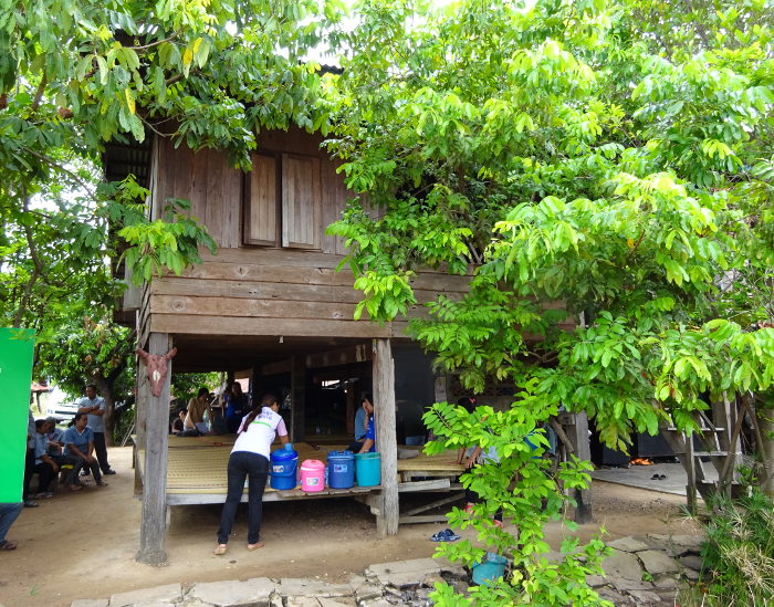 Visit of Health and Share Foundation Staff members and local health workers to the home of Mai, a very capable HIV-AIDS orpha with a physical disability.