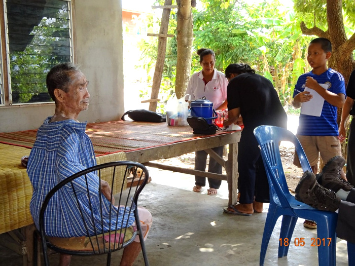 The man’s young buddy (standing, on right) was eager take him out to sit in the sunlight each time he visited, to see if that might help his skin condition.