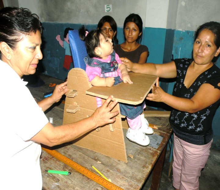 Cardboard-based assistive equipment has been a feature of low-cost assistive-technology workshops I have facilitated in Asia, Africa, and Latin America. Here, in a workshop in Peru, family members and community rehab workers make a cardboard seat for a child with cerebral palsy.