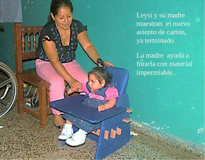 After the seat was completed and tested for the child, her mother helped upholster it with an impermeable cloth.
