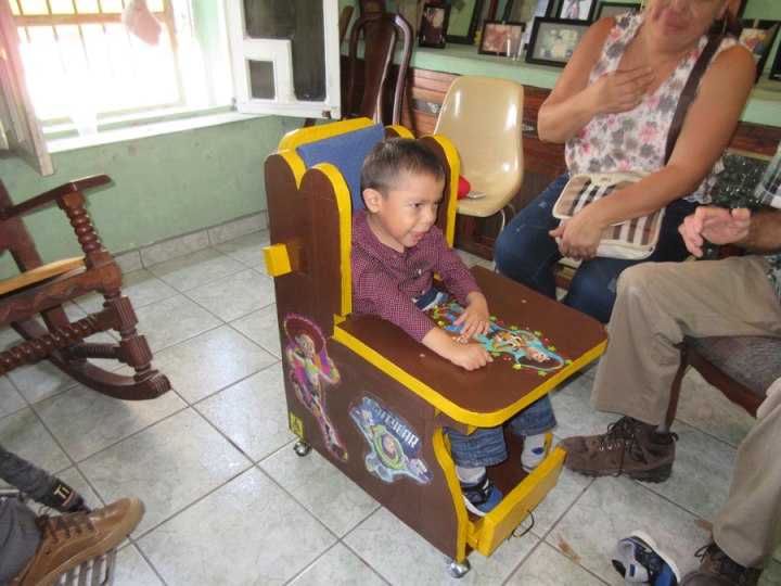 Julian is delighted with his new seat. It allows his mother to adjust the angle of his back and lower legs. To rest, she can lower the back and lift his feet. To feed him she can sit him up straighter.
