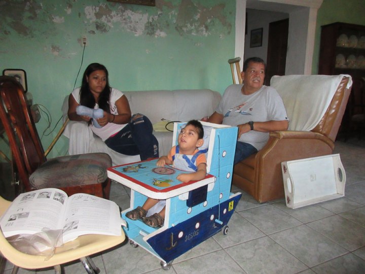Jesus Ariel has microcephaly and developmental delay with quite limited head and body control. His special seat—which his parents asked to be in the form of a boat—can be adjusted to allow change of position, and includes wedges and cushions so his head can be placed comfortably.