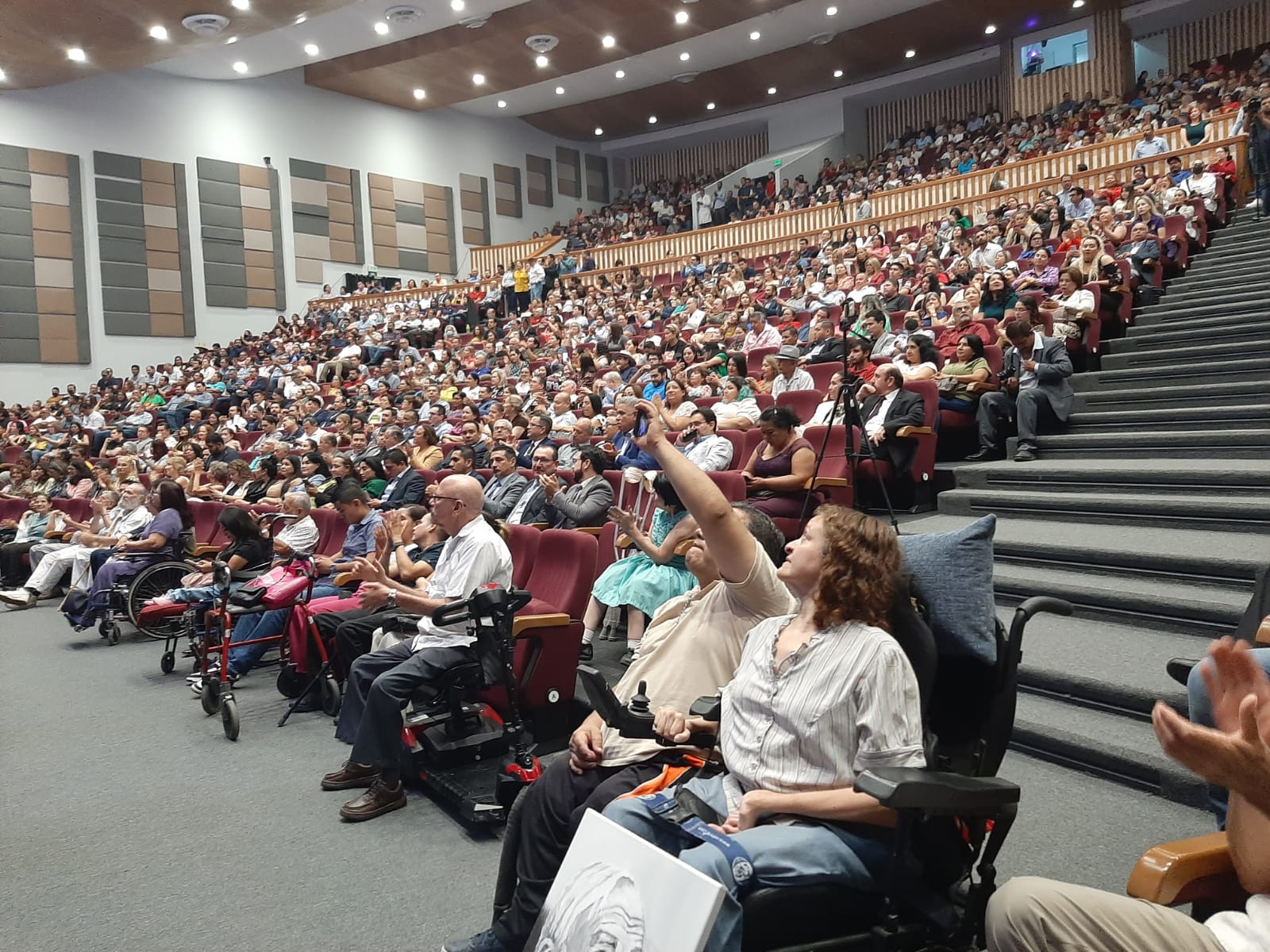 For the award ceremony, the 600-seat auditorium was overflowing. Lots of disabled friends attended. In the foreground in her wheelchair is Lilí Chaidez, with a portrait of me she painted with her mouth. (See below.)
